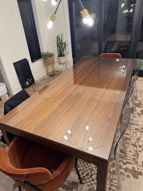 Custom glass top protecting a walnut dining table